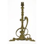 An Arts and Crafts brass table lamp,in the manner of W A S Benson, having stylised scroll handle and
