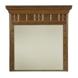 An oak overmantel mirror,with a castellated frieze over inlaid panels with flowers and roundels, the