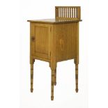 An oak pot cupboard, the raised and turned gallery over a panelled door with a ring handle and