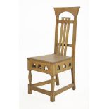 An Arts & Crafts oak hall chair,with vertical splats and a solid seat over a spade pierced frieze,