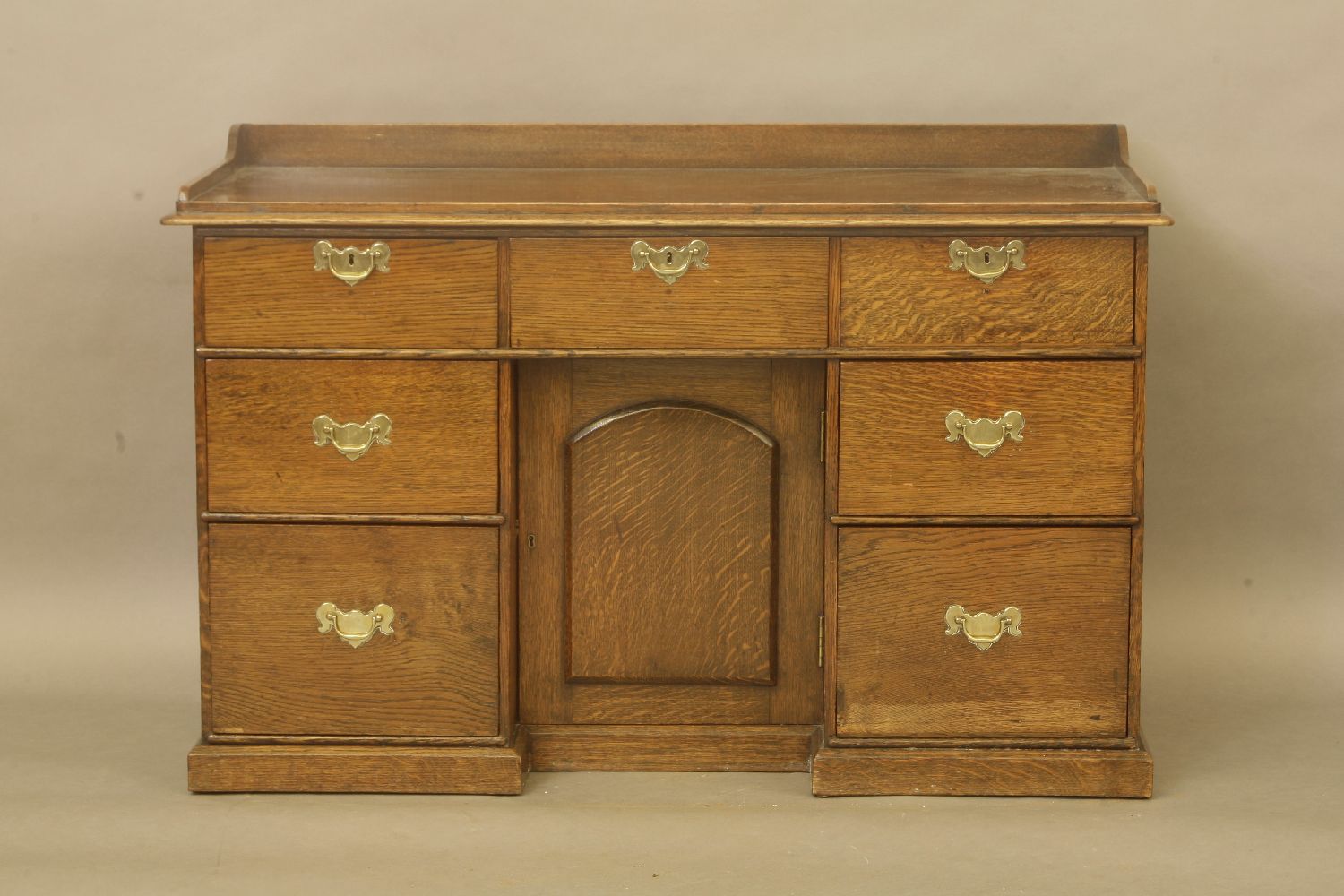 A 20th century oak kneehole desk, with three frieze drawers, each pedestal with two short drawers,