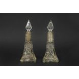 A pair of silver topped perfume bottles, the cut glass bodies with elongated neck and silver collar,