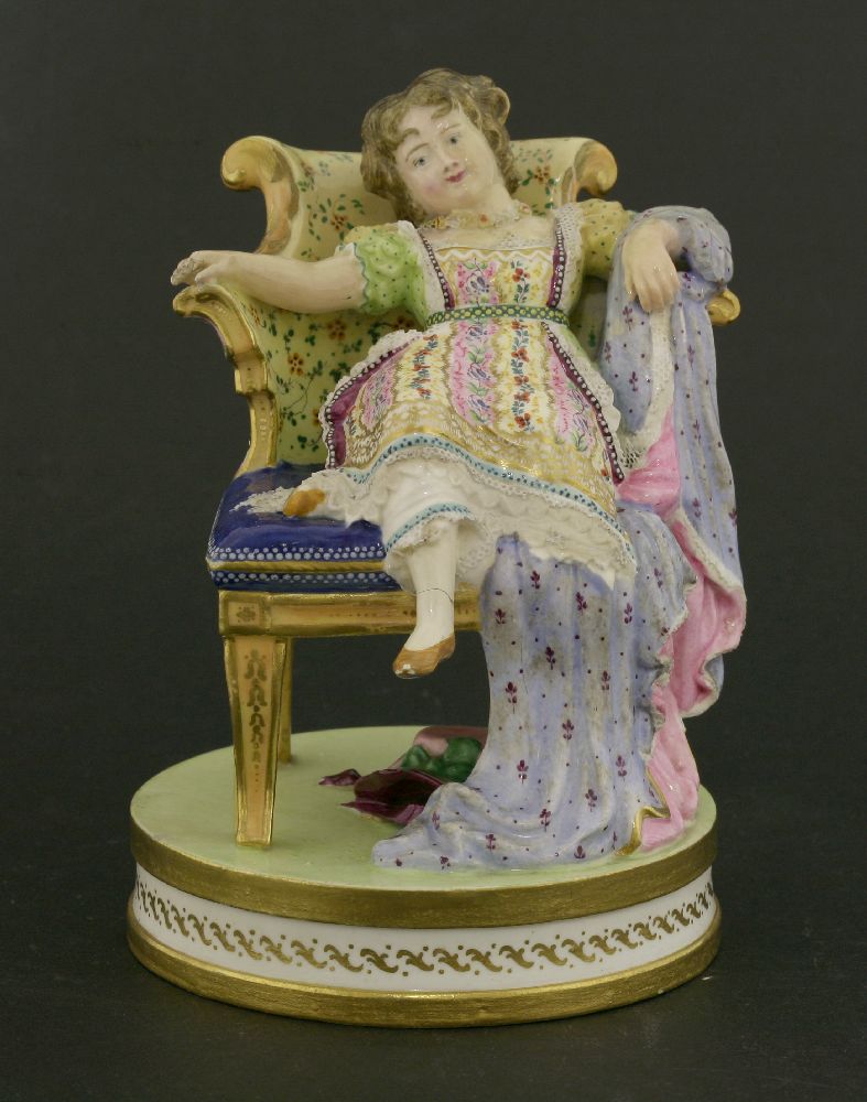 A Minton polychrome ceramic figure,of a young girl lounging on a chair, mounted on a circular gilt