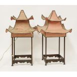 A pair of unusual Chinese hardwood table lamps,in the form of pagodas with silk shades and carved