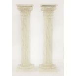 A pair of Cornithian column simulated marble pedestals, carved wood and painted, each 119cm high (