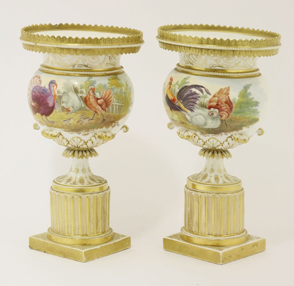A pair of porcelain urns, both gilt decorated and painted with chickens and turkeys, with landscapes