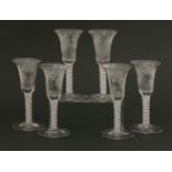 Six George III-style wine glasses,with double air twist stems, each with bell-shaped bowls, on