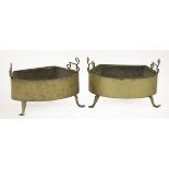 A pair of brass braziers,18th century, with scroll handles, on front lion paw feet,57cm wide (2)