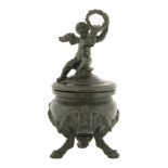 An Italian bronze inkwell,19th century, cast as a cauldron with ram's head masks and garlands, on