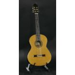 A 1989 Manuel Contreras classical guitar,of typical form and of golden colour with chevron binding