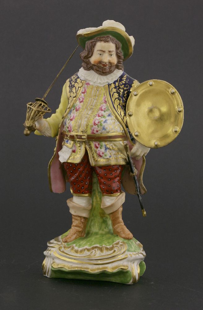 A Derby figure of Sir John Falstaff,standing on a naturalistic base, with applied gilt metal