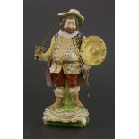 A Derby figure of Sir John Falstaff,standing on a naturalistic base, with applied gilt metal