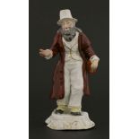 A Rockingham porcelain figure,c.1820, of 'The Jewish Money Changer', mounted on a rocaille decorated