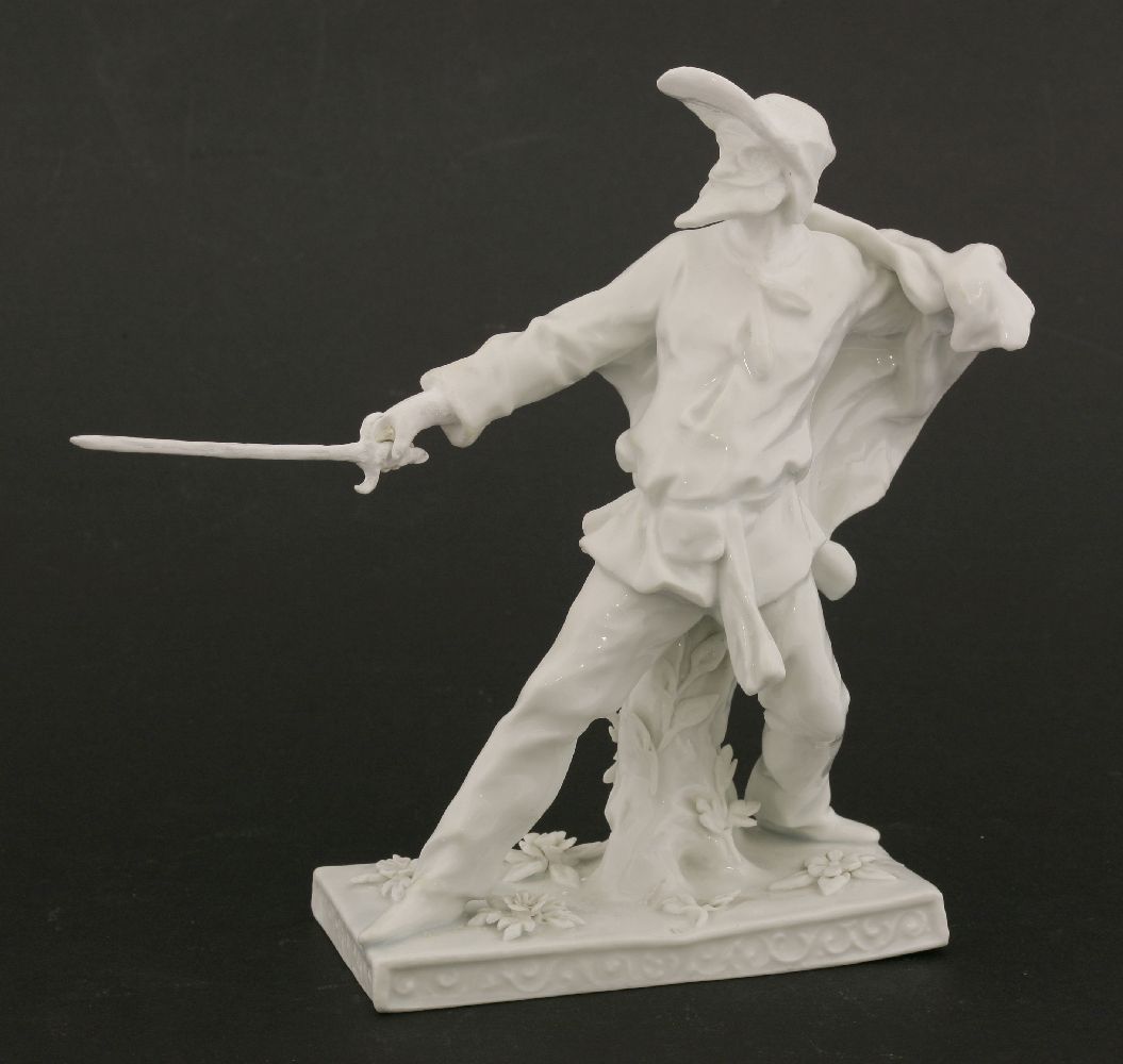 A Komodie figure,of a captain brandishing his sword, on strewn rectangular base, damage, with