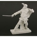 A Komodie figure,of a captain brandishing his sword, on strewn rectangular base, damage, with