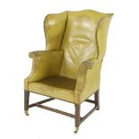 A George III wing armchair,upholstered in yellow leather on moulded square legs