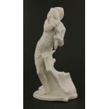 A Komodie white porcelain figure,of Harlequin cradling a swaddled monkey, on shaped base, incised