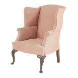 A walnut-framed wing armchair, in the Queen Anne style, with recent upholstery