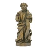 A German stained walnut figure of St. Peter,probably 17th century, holding a long scroll, lacking