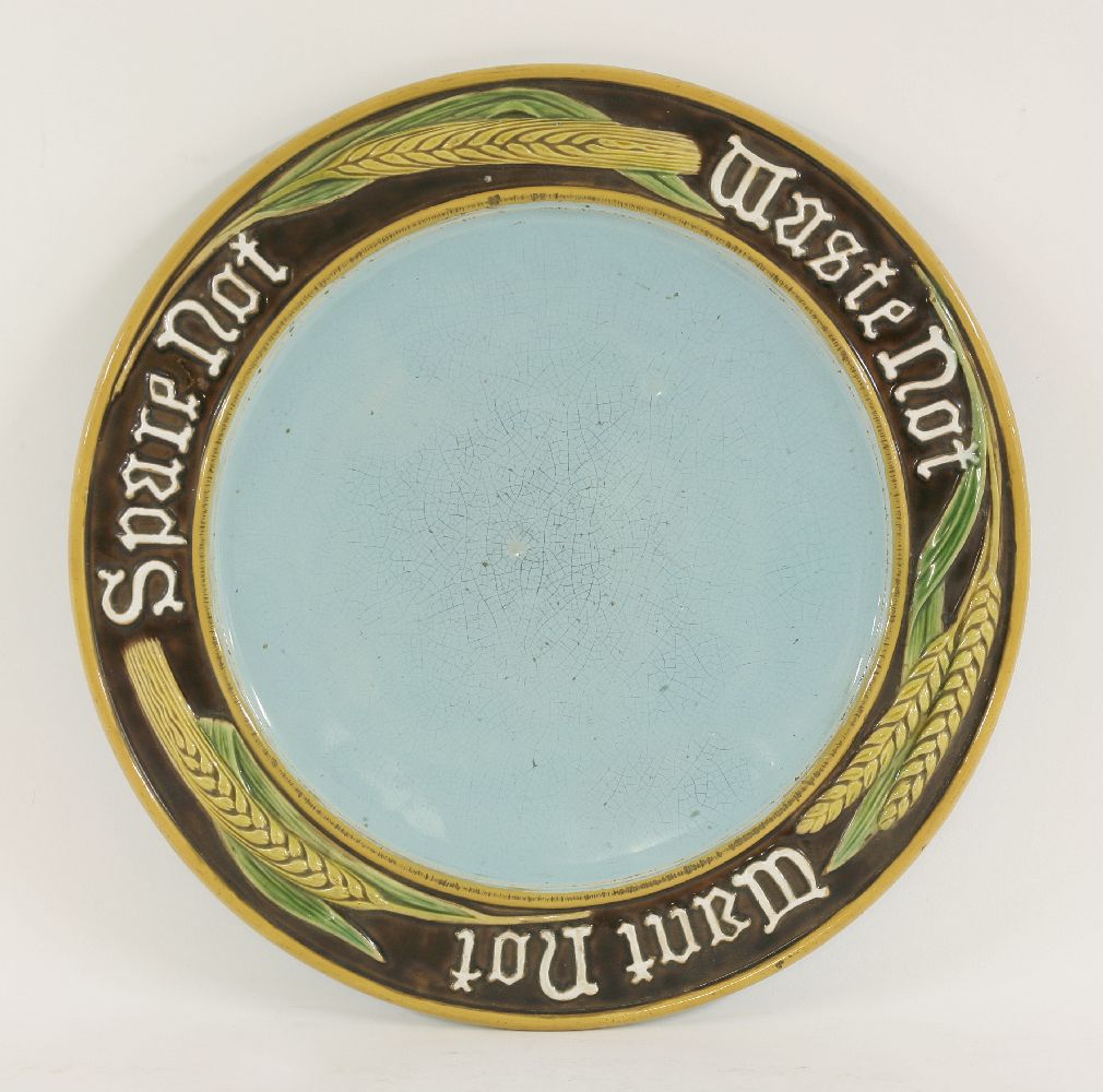 A Minton majolica bread plate, dated 1877, with a moulded border with wheat and barley ears and '