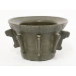 A Spanish bronze mortar,probably 15th century, of tapering form with cast designs to the outer