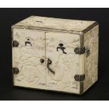 A Japanese ivory miniature cabinet, c.1880-1900, each panel carved in low relief with figures,