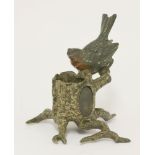 An Austrian cold painted bronze vesta,modelled as a robin perched on a tree trunk, with an oval