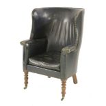 A George III tub armchair,the rounded back and seat upholstered in green leather with brass studs,