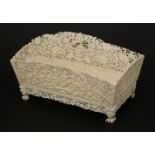 A Chinese Canton ivory desk stand,c.1880-1890, with two divisions, profusely carved with floral