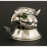A cast silver-plated parrot head tape dispenser,with green glass eyes, stamped 'Made in Italy',9cm