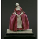 A Chelsea Cheyne figure,of Polly Peachum from the Beggars Opera, in a pink dress, with hands