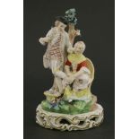 A Derby figure of ‘the stocking mender’,c.1820, the man stands while the female mends his