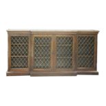 A Regency rosewood breakfront dwarf bookcase,the later marble top over four grille doors, adjustable