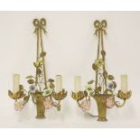 A pair of French brass and porcelain twin branch wall lights,each modelled as a basket of flowers,