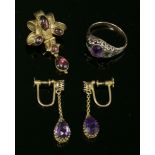 A pair of gold and amethyst drop earrings, c.1900,with a circular mixed cut amethyst, claw set at