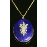 An oval gold, enamel and diamond hinged locket, c.1910,with royal blue guilloché enamel decoration