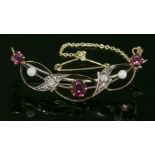 A late Victorian ruby, diamond and cultured pearl open crescent brooch, c.1890,of ribbon form. A