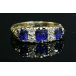 An 18ct gold, Victorian, sapphire and diamond carved head ring, c.1890,three graduated oval mixed