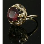 A Victorian garnet, diamond and enamel head, later mounted as a ring,with a circular mixed cut