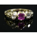 A Victorian three stone pink sapphire and diamond ring,with a cushion-shaped pink sapphire, four