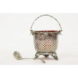 A Victorian silver basket, with a pierced body and swing handle, with a cranberry glass liner,