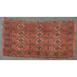 A small Persian Belouch hand knotted rug, the red fields with repeating geometric motifs