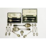 A pair of Georgian fiddle pattern table spoons, two cased christening sets, and other items