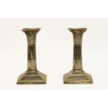 A pair of dwarf silver candlesticks, Birmingham, 1900, on square stepped bases, 16cm high
