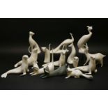 Fourteen various Royal Dux porcelain figures of animals, the majority decorated in white glaze,
