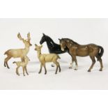 A family of Beswick deer, and two horses