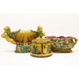 A large polychrome majolica ware centrepiece, in the form of Ruth holding a shell, together with a