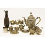 A Persian silver coffee set, consisting a pot, eleven cups, twelve saucers, two cream jugs, together