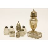 Silver items: sugar shaker, pepperette, two silver topped jars, a silver dressing table box and four