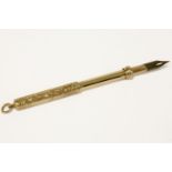 A gold self propelling telescopic fountain pen, with engraved scrolling motifs, marked 9ct 15.86g